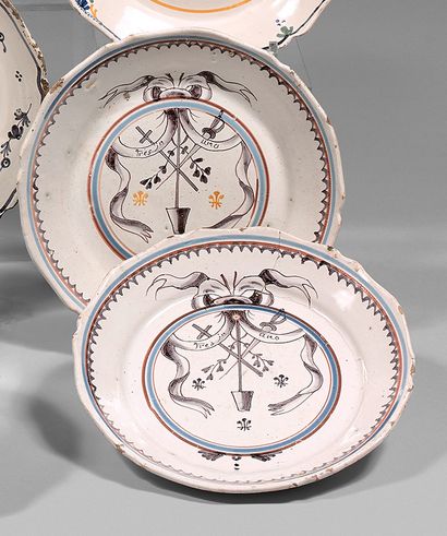NEVERS Two earthenware plates with a contoured border, decorated in manganese violet...