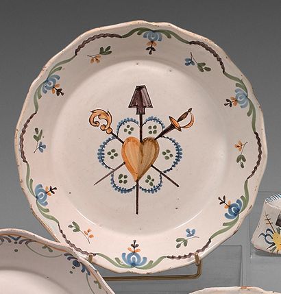 NEVERS Earthenware plate with contoured border, polychrome decoration of the three...
