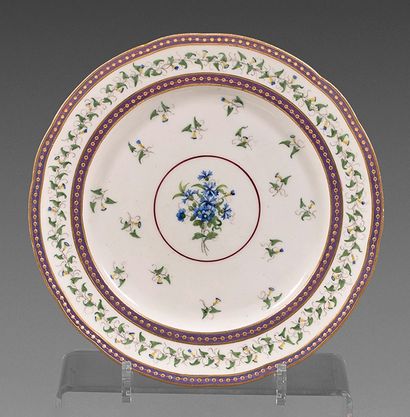 SÈVRES Plate in soft porcelain with contoured border, decorated with a bouquet of...