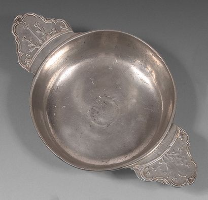 Pewter ear bowl with molded decoration on...
