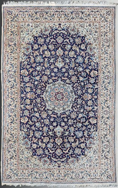 null Naïn carpet with a central floral medallion and arabesques on a cream field...