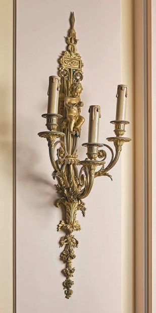 null 
A pair of three-light sconces in finely chased and burnished bronze in the...