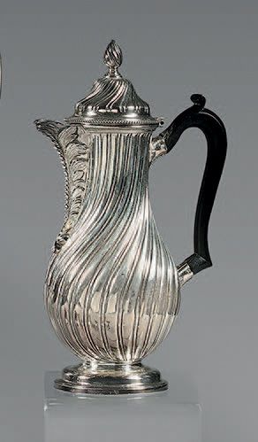 null Silver pot, on pedestal, the body with twisted ribs, the spout foliated, the...