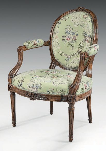 null A molded and carved beechwood cabriolet back armchair decorated with stylized...