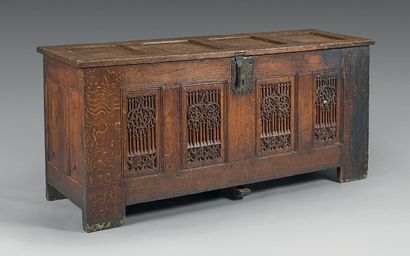 null A molded and finely carved oak chest, the panels with windows framed by doucines...