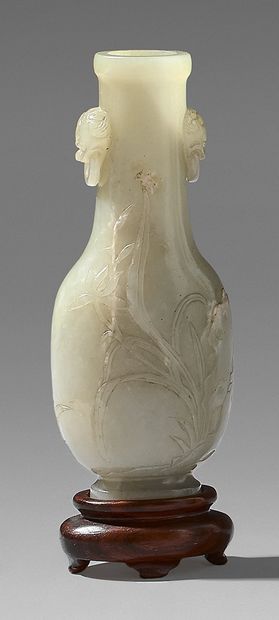 CHINE A small clear nephrite vase with chased decoration of irises in their foliage,...