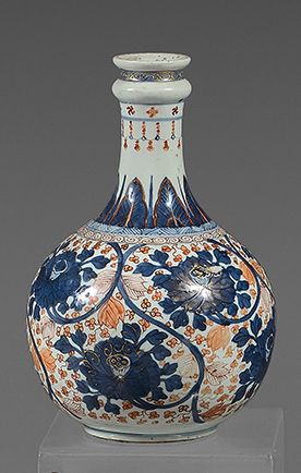 CHINE A narrow-necked porcelain bottle decorated in the imari palette with scrolling...