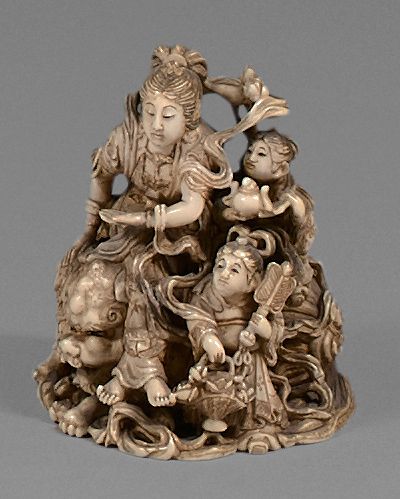 JAPON Okimono in ivory, Benten riding a lion accompanied by two children.
Signed...