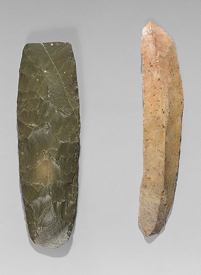  Lot including a blade with finely retouched edges and a carved adze. Brown flint...