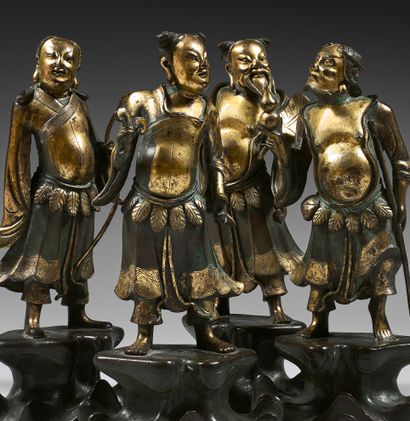 CHINE Set of four bronze statuettes with brown patina and traces of gilding of four...