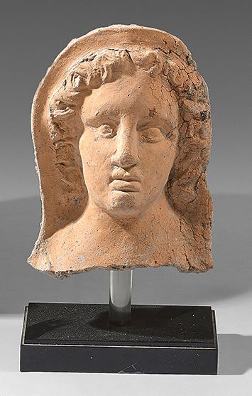  Ex-voto of a veiled woman. Orange terracotta. Chipping at the base. Great Greece,...
