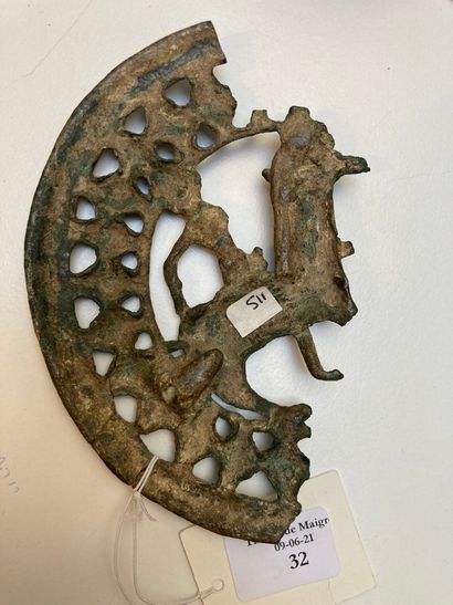  Fragment of a circular openwork belt buckle with a rider motif passing to the left....