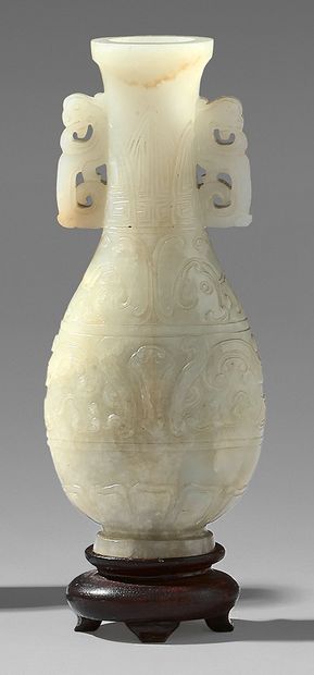 CHINE Small archaizing vase in clear nephrite with carved decoration on the body...