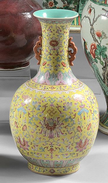 CHINE A yellow-ground porcelain baluster vase decorated in famille rose enamels with...