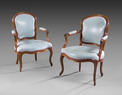 null Pair of cabriolet back armchairs in moulded walnut; cambered arm brackets; moulded...