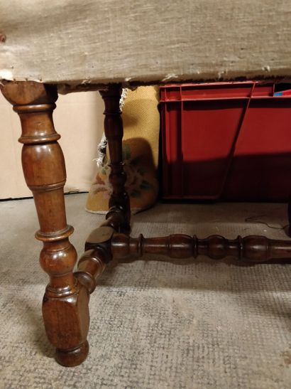 null Walnut turned bench resting on six turned baluster feet joined by an H-shaped...