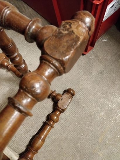 null Walnut turned bench resting on six turned baluster feet joined by an H-shaped...