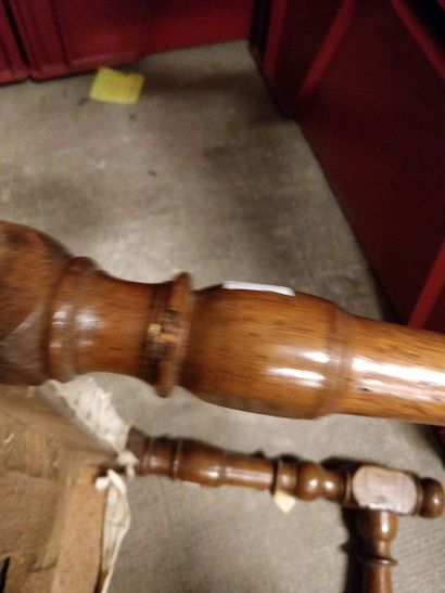 null Walnut turned bench resting on six turned baluster feet joined by an H-shaped...