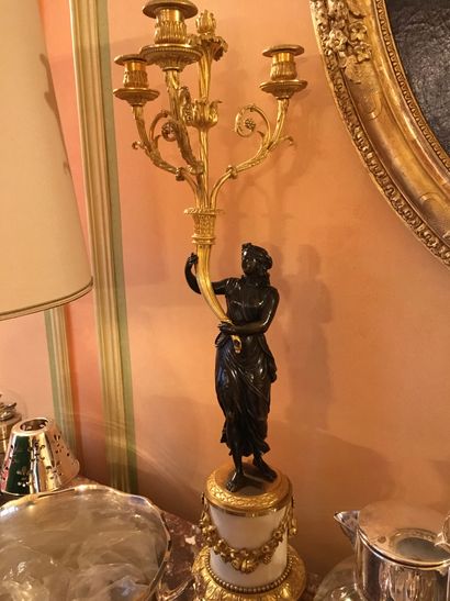 null Pair of candelabras in patinated and gilt bronze, representing vestals supporting...