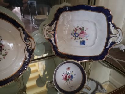 null Tea service in porcelain of Paris with floral decoration and blue and gold border...