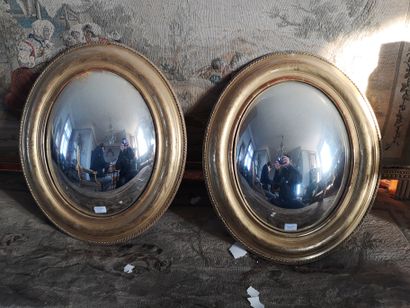 null Pair of oval witch mirrors. End of the XIXth century. Ht 50 x 38 cm. (accidents)....