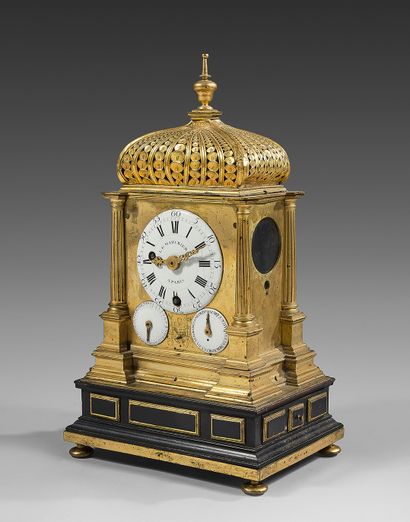 null Rare gilt bronze or copper chased clock. Of architectural form, the cover with...