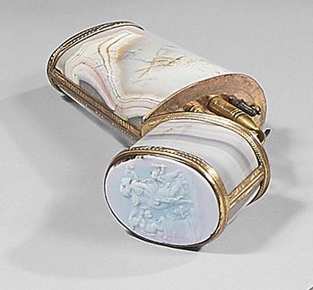 null An oval sectioned agate pompom-mounted case, containing various utensils including...