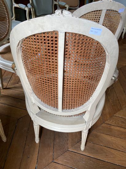 null Pair of chairs and two armchairs, lacquered and caned 

Louis XVI style 

H...