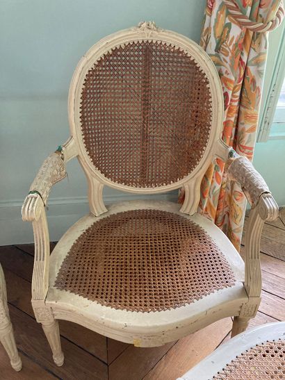 null Pair of chairs and two armchairs, lacquered and caned 

Louis XVI style 

H...