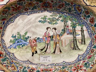  Oval poly-lobed beard or pipe dish enamelled on copper, with characters in a reserve...