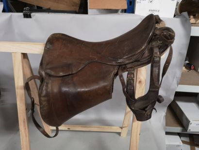 null Old leather saddle. Two pairs of saddlebags are attached, one of which is for...