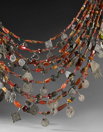 null Necklace with nine rows held by a silver triangle and niello at each end. Each...