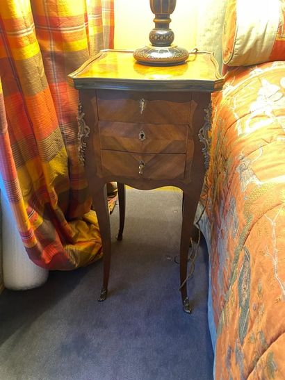 null Bedside table in rosewood veneer, curved legs, opening with three drawers, ornamentation...