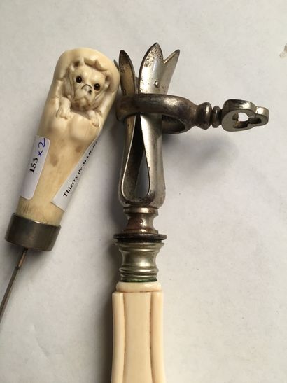 null Paper-cutter, ivory handle carved with a dog coming out of a stump, the eyes...
