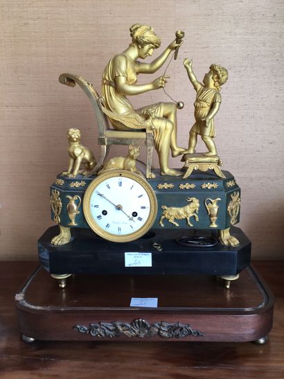 Clock in gilt bronze and patina, decorated...