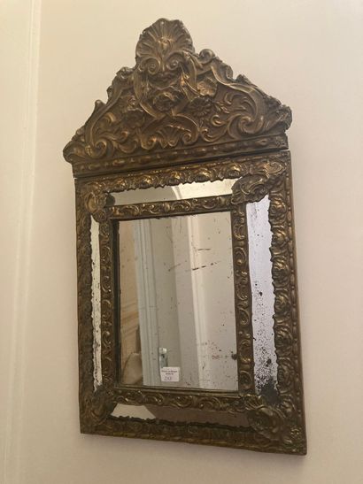 Small brass embossed mirror with pediment

Louis...