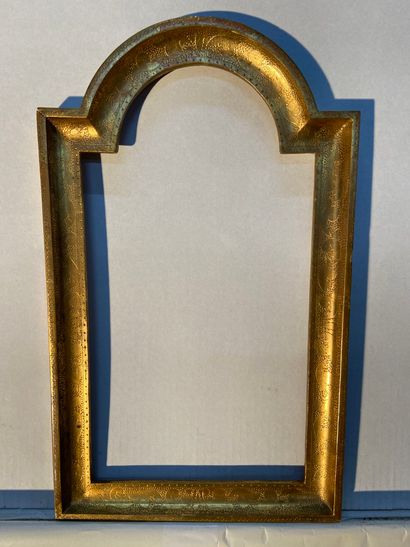 Gilded wood frame, the top arched and decorated...