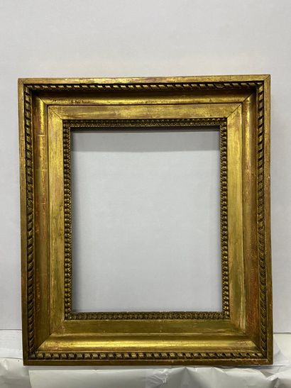 Carved and gilded oak frame decorated with...