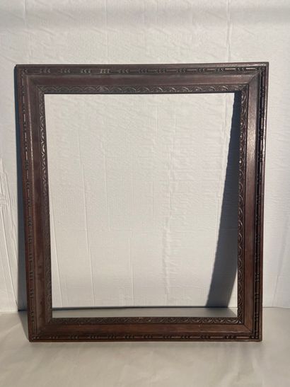 Carved oak frame decorated with scrolls and...