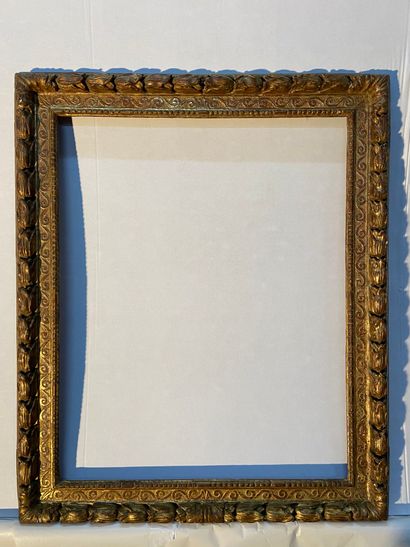 Carved and gilded limewood frame decorated...