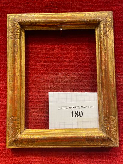 Small carved and gilded limewood frame with...
