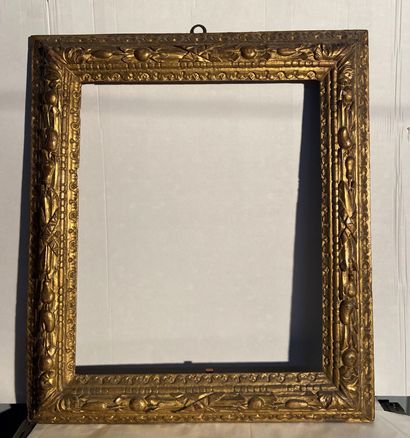 null Carved and gilded limewood frame with reversed profile

decorated with a frieze...