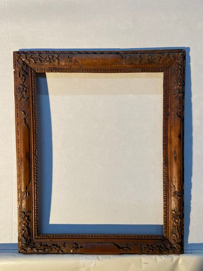 Frame in natural limewood carved with scrolls...