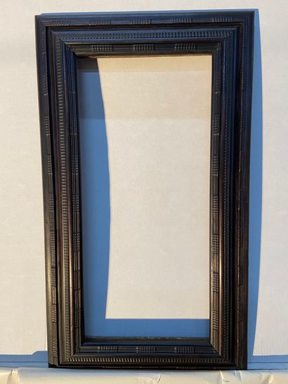Frame in molded and blackened wood with guilloche...