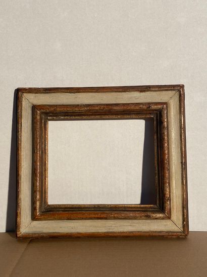 null Moulded limewood frame with grey and old silver plated inverted profile

Italy,...