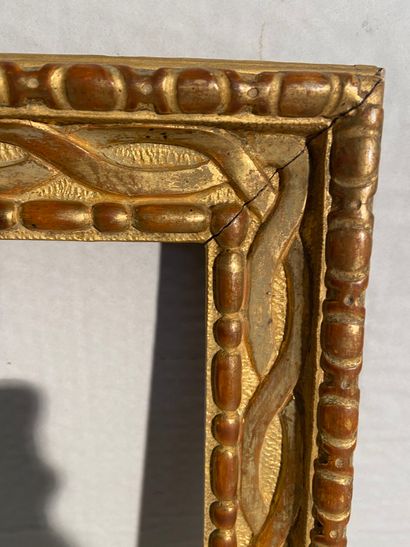 null Carved and gilded wood frame decorated with grapes and interlaced foliage

18th...