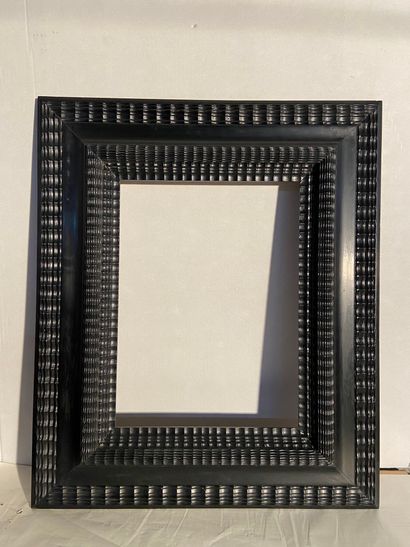 Frame in molded and blackened wood with reversed...
