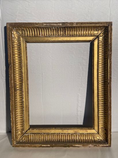 Carved and gilded oak and paste frame decorated...