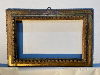 Carved and gilded wood frame with inverted...