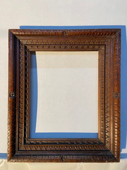 Frame in natural wood carved with friezes...